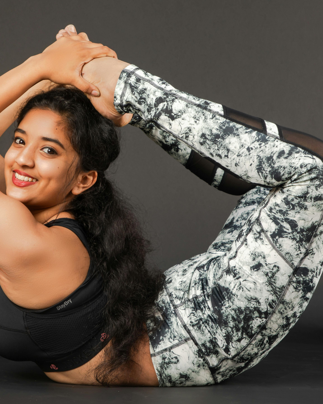 Woman performing a deep backbend yoga pose, showcasing strength, flexibility, and body control